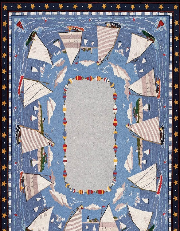 Rectangular rug with a central open area surrounded by a design featuring multiple sailboats in shades of blue and white.