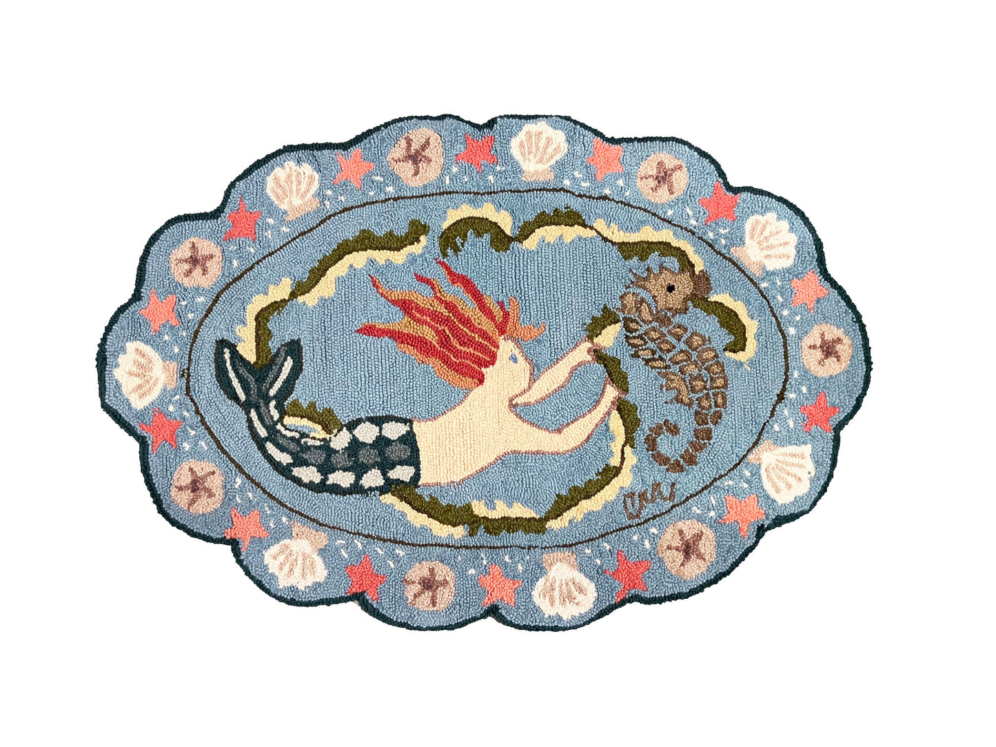 Decorative rug with mermaid and seahorse design on a blue background