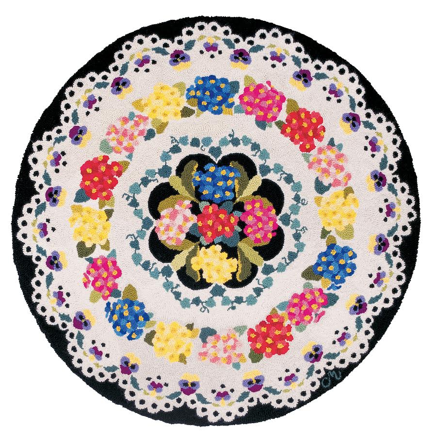 Round hand-hooked wool rug with colorful floral pattern on a white background