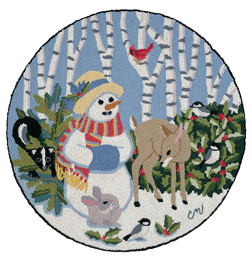 A round hand-hooked rug featuring a snowgirl with a fawn, and other woodland creatrues