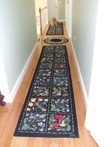 Decorative runner rug with floral and nature-themed patterns on a wooden floor.