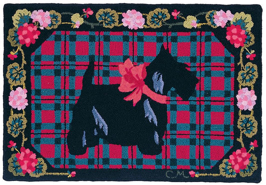 Decorative mat with a blackScottish terrier silhouette, pink bow, and floral border on a plaid background.