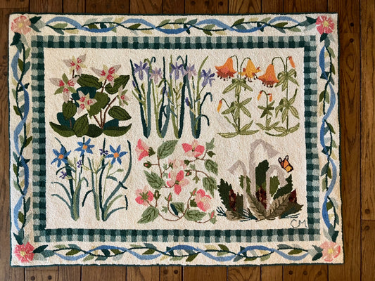 Decorative rug with floral and leaf patterns on a wooden floor