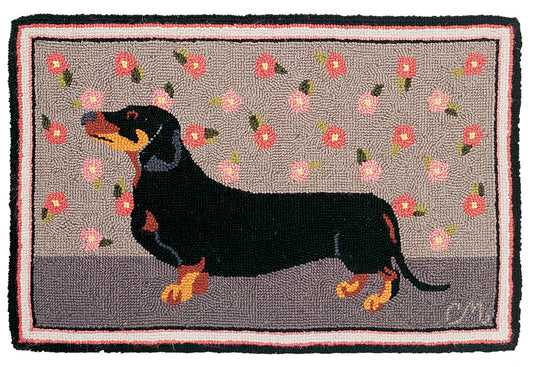 Decorative rug with a black dachshund and floral pattern on a gray background