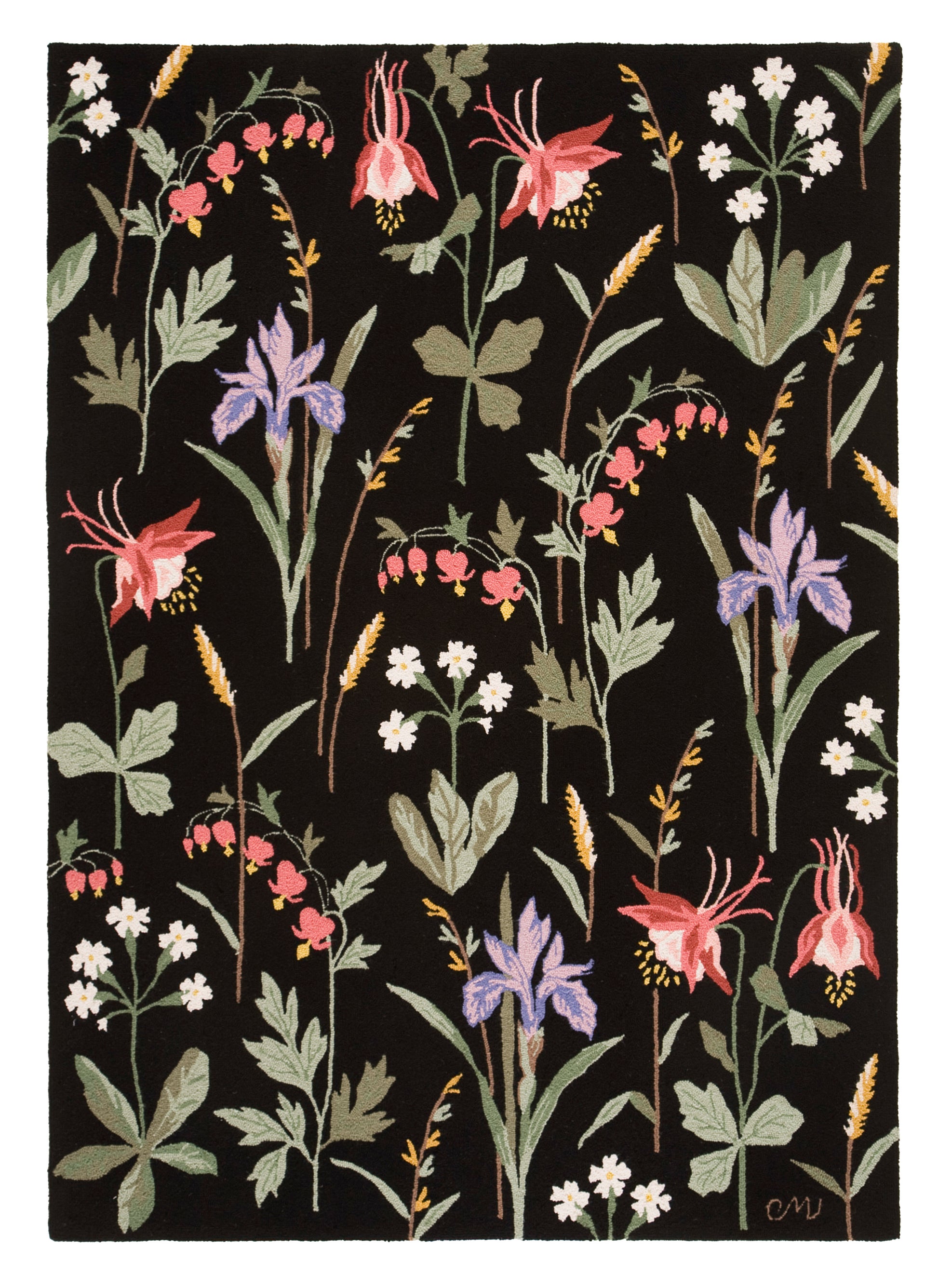 A rectangular area rug featuring a dense, vintage-style botanical pattern of wildflowers on a solid black background. The floral design includes pink columbines, purple irises, white flowers, and green leaves, with a small gold monogram signature in the bottom right corner.