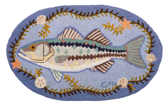Decorative rug with a fish design on a blue background