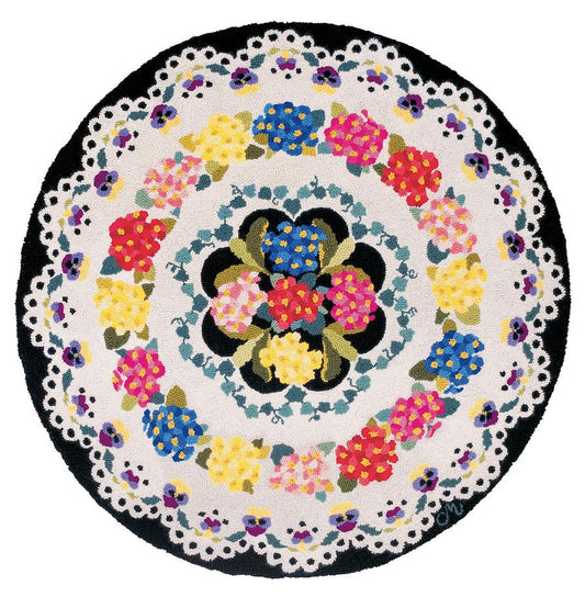 Round hand-hooked wool rug with colorful floral pattern on a white background