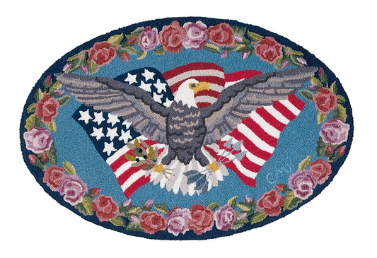 Decorative rug with an eagle and American flag design surrounded by flowers on a blue background