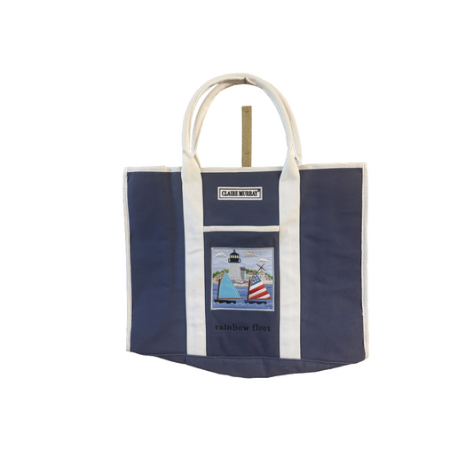 Navy tote bag with white handles and a lighthouse design on a white background