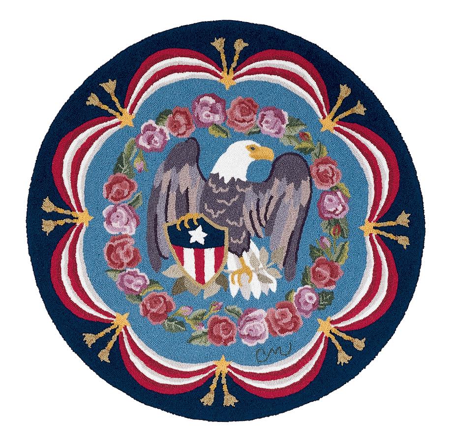 Roundel with a bald eagle and shield design, surrounded by flowers and decorative elements on a blue background.