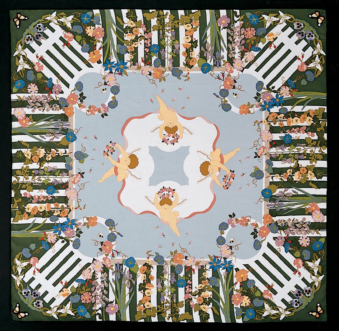 This is a square silk scarf featuring a white picket fence bordered by colorful flowers and winged cherubs in the center.